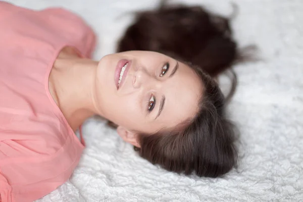 Close up.thoughtful young woman lying on white carpet in living room — Stock Photo, Image