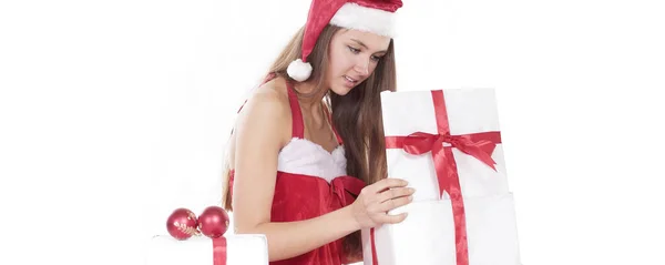 Beautiful young woman in a Christmas costume looking at a box o — Stock Photo, Image