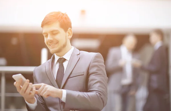 Portrait of handsome businessman on blurred office background — Stock Photo, Image