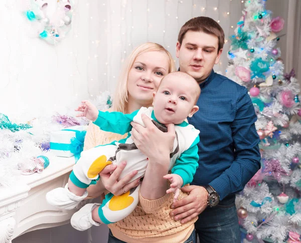 Loving parents show their baby Christmas gifts — Stock Photo, Image