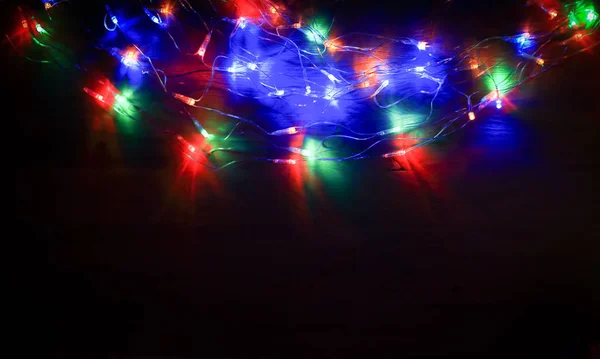 Christmas tree garland laid out on a wooden table — Stock Photo, Image