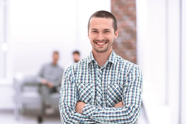 Young employee standing next to office window — Stock Photo, Image