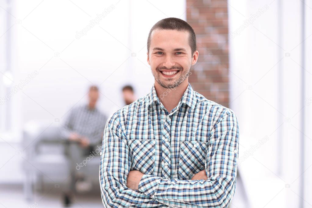 young employee standing next to office window