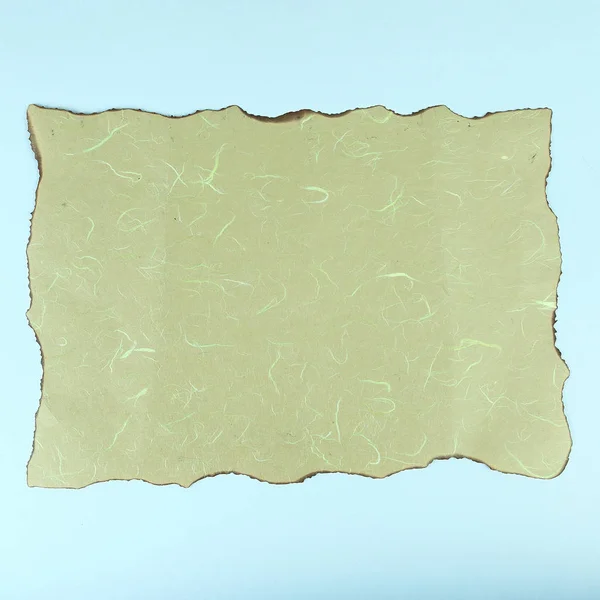 Burnt sheet of paper on a white background — Stock Photo, Image