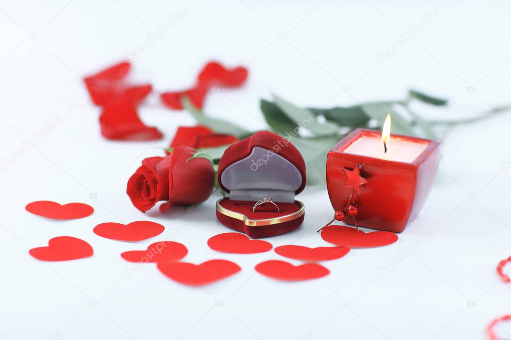 burning candle and red rose on white background.photo with copy 