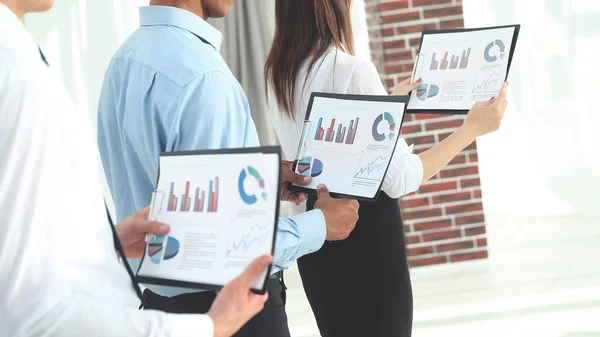 business team with financial reporting standing in the office.