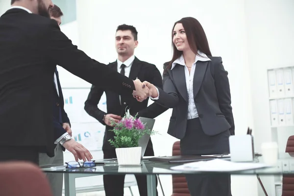 Businesswoman handshake with business partner in modern office — Stock Photo, Image