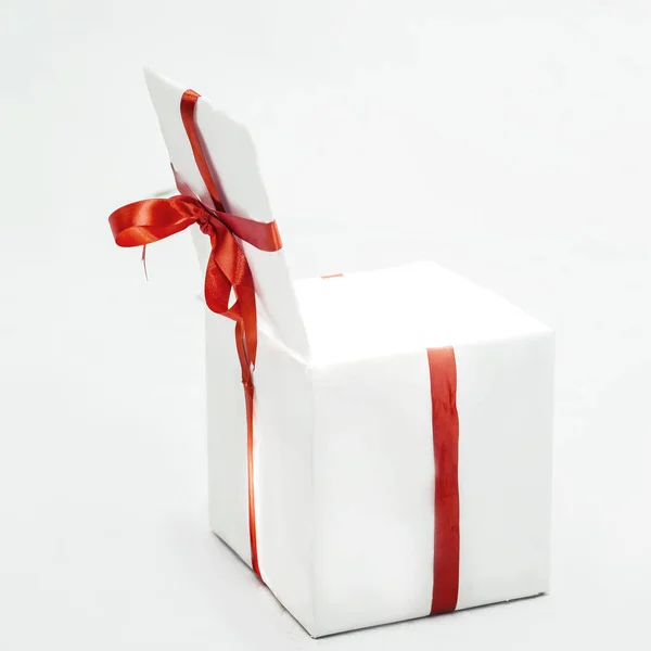 beautiful white box with a red ribbon with the purchase