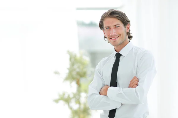 Serious young businessman on background of office — Stock Photo, Image