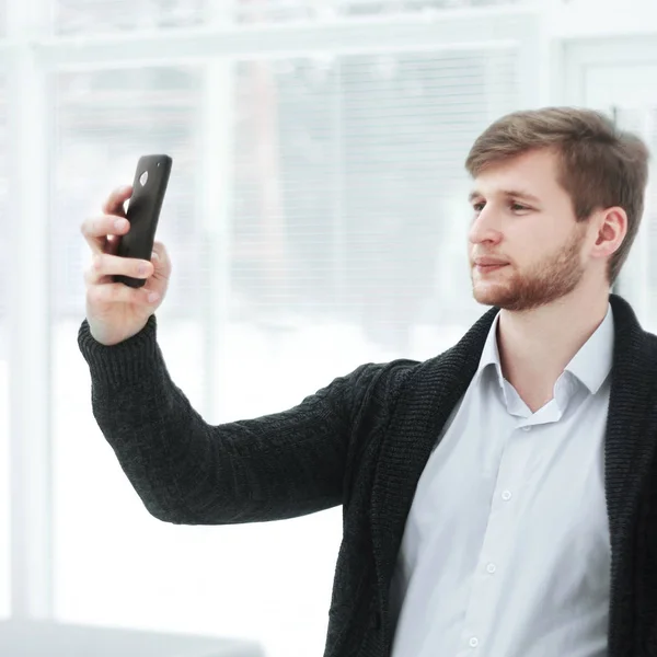 Creative young man takes a selfie in a modern office — Stock Photo, Image