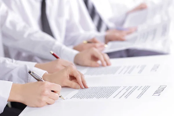 Close up. a group of business people studying the terms of the c — Stock Photo, Image