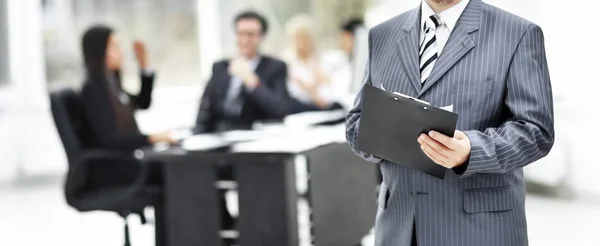 Torso of a businessman with documents at office background — Stock Photo, Image