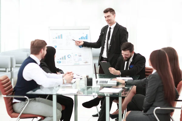 Finance Manager pointing a marker on the flipchart with financial data — Stock Photo, Image