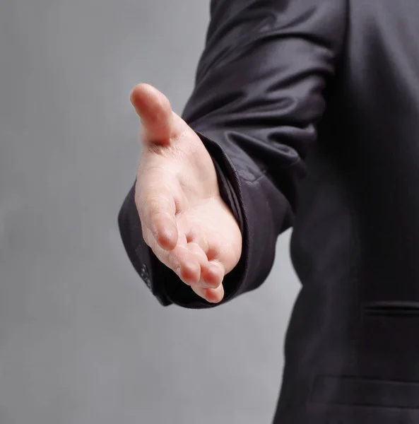 Exitoso hombre de negocios se extiende para un handshake.isolated en g — Foto de Stock