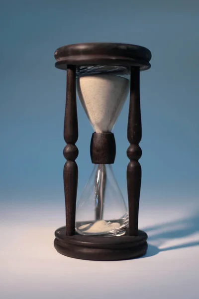 Closeup of hourglass. isolated on blue background. — Stock Photo, Image