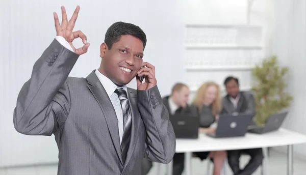 Foreground of a businessman showing OK gesture — Stock Photo, Image