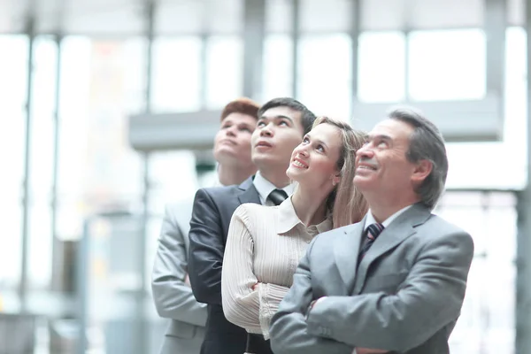 Close up. boss and business team looking up at copy space — стоковое фото