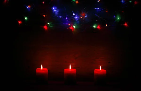 Three candles on an abstract festive background — Stock Photo, Image