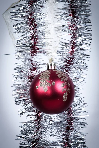 Bola roja de Navidad y guirnalda dorada sobre fondo blanco — Foto de Stock