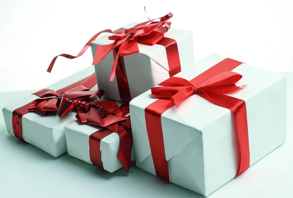 Closeup.boxes with gifts with a beautiful red ribbon — Stock Photo, Image