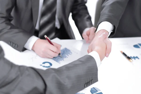 Close up.the financial partners shaking hands over a Desk — Stock Photo, Image