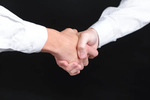 Zblízka. handshake obchodní partnery. izolované na černém pozadí — Stock fotografie