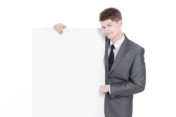 Exitoso joven hombre de negocios mirando banner en blanco — Foto de Stock