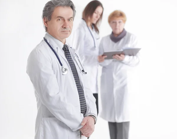 Serious therapist doctor on blurred background of colleagues — Stock Photo, Image