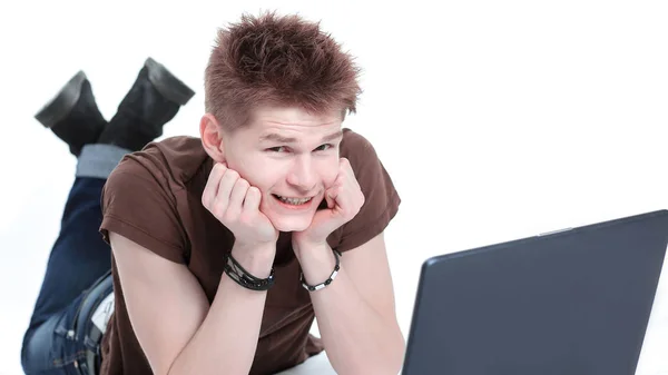 Closeup. modern guy working on laptop lying on the floor. — Stock Photo, Image