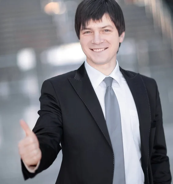 Friendly businessman holding out hand for a handshake — Stock Photo, Image