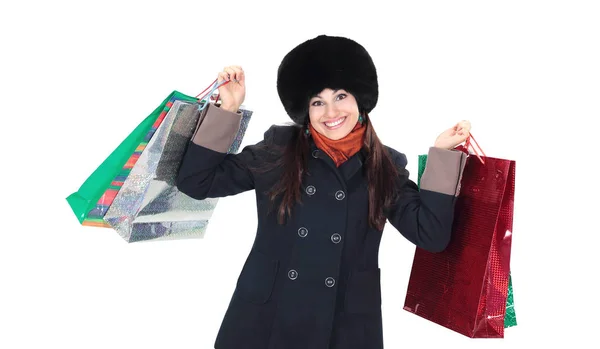 Jonge vrouw in winterkleren met shopping tassen — Stockfoto