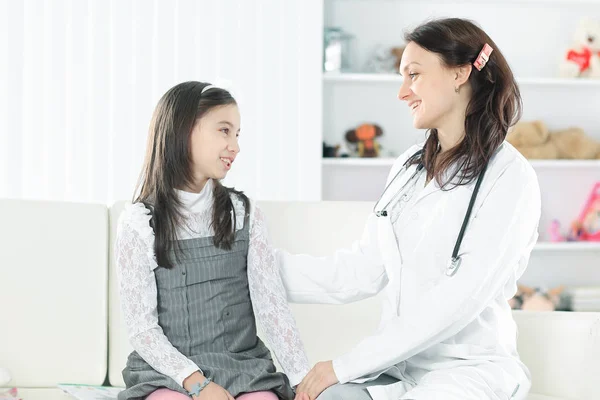 Pediatra, falando positivamente com uma menininha. Foto com espaço de cópia — Fotografia de Stock