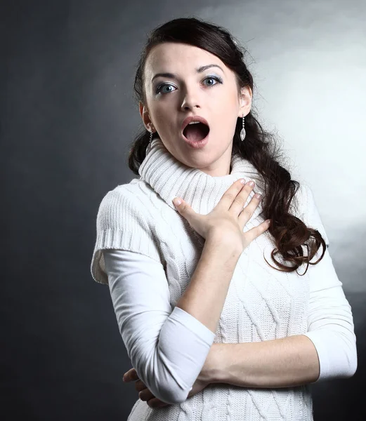 Portrait of a surprised young woman in white sweater .isolated — Stock Photo, Image