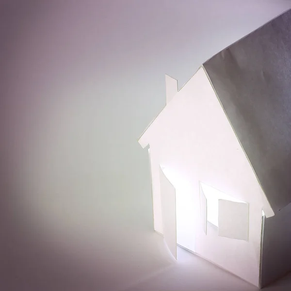 Primer plano de una casa de papel para el fondo de papel . — Foto de Stock