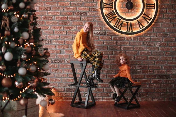 Irmãs bonitas sentadas em uma elegante sala de estar na véspera de Natal — Fotografia de Stock