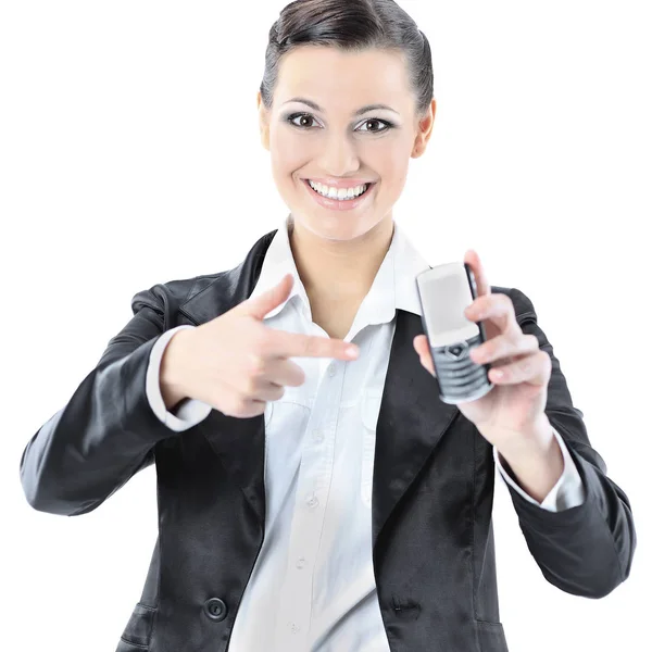 Beautiful business woman points to the phone. Isolated on a white background. — Stock Photo, Image