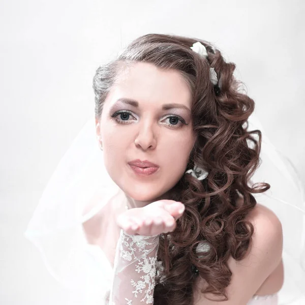 Young attractive bride in wedding dress sends a kiss — Stock Photo, Image