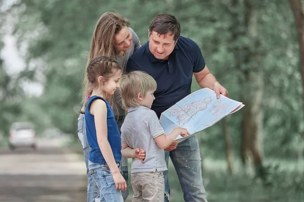 family with their children discussing the route on the map