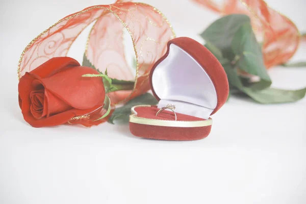 Anillos de boda y rosa roja sobre fondo blanco.foto con copia s —  Fotos de Stock