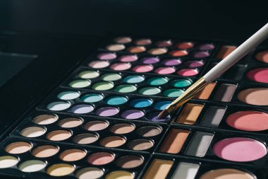 close up. makeup brush and beige eye shadow