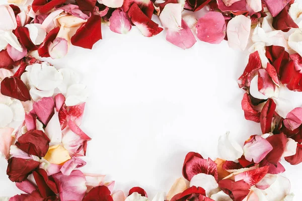 Box with ring and rose petal frame on wooden background — Stock Photo, Image