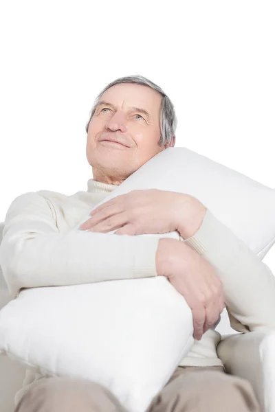 Elderly man with a comfortable pillow.isolated on white — Stock Photo, Image