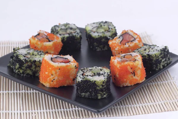 Sushi Set - different types of Maki sushi and chopsticks on a b — Stock Photo, Image