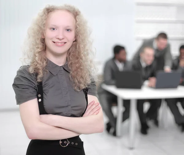 Young female assistant showing OK sign,standing in the office — Stock Photo, Image