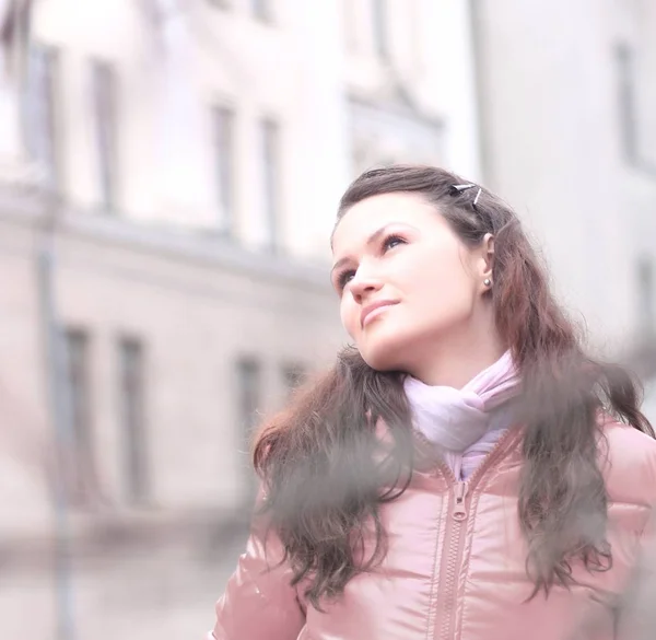 Young woman in red autumn jacket on a background of city — Stock Photo, Image