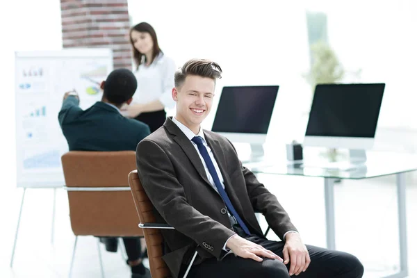Portrait of young employees sitting near the desktop — Stock Photo, Image