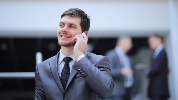 Portrait of handsome businessman on blurred office background — Stock Photo, Image