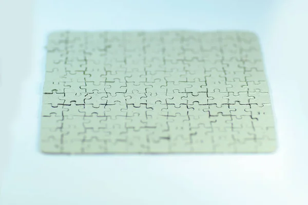 Close up. blank card collected from puzzle pieces on a white sheet — Stock Photo, Image