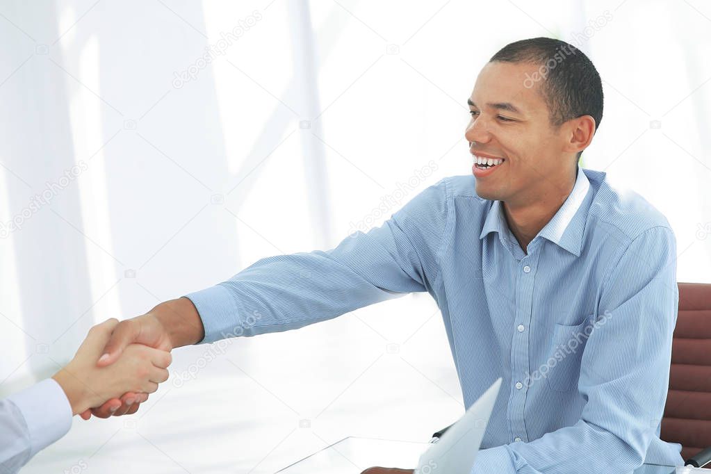 closeup. businessman shaking hands with his partner.
