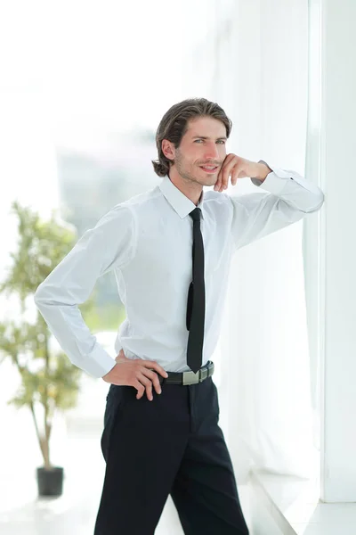 Serious young businessman on background of office — Stock Photo, Image